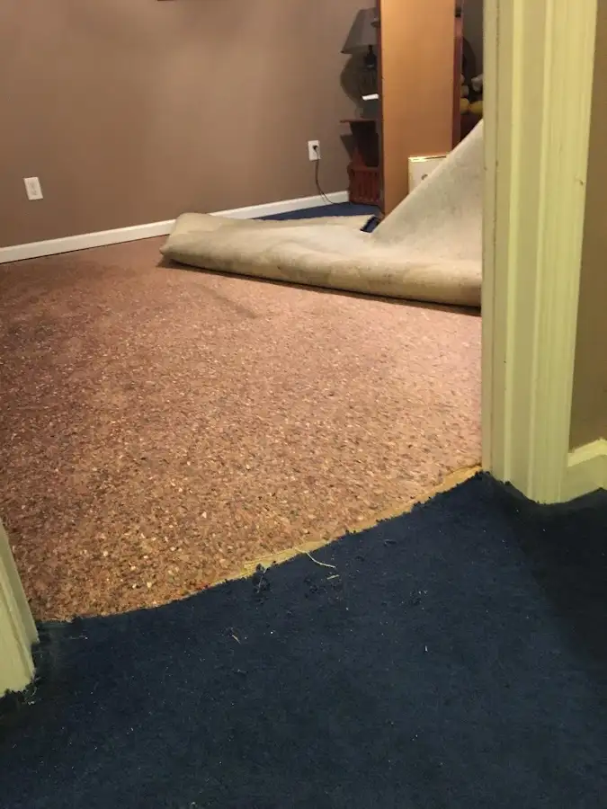 Carpet pad removal revealing water damage during Drying & Dehumidification in Burnet